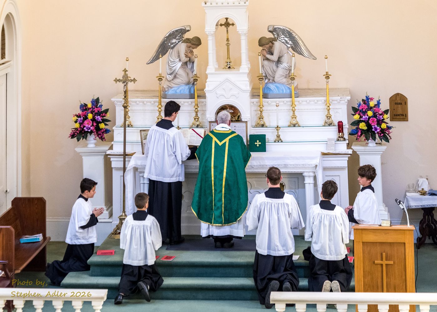 Servers kneeling at the altar steps